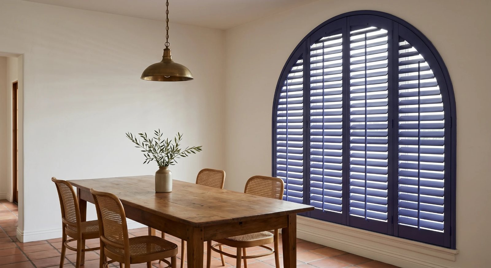 Custom arched whole basswood shutters on a Spanish Revival window in a San Gabriel Valley home